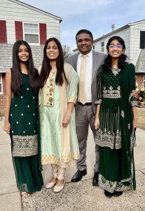 Vibrant family celebrating outside Windsor Chapel, a Spirit-filled evangelical Christian church, in traditional attire.