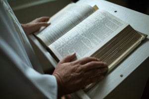Bible open during prayer or worship at Windsor Chapel, a Spirit-filled evangelical church.